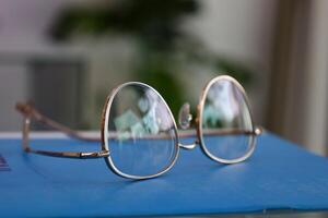 Eyeglasses on table, progressive lenses, eyeglasses for the elderly, glasses progressive lens, eyeglass progressive lens, close-up of glasses on lenses test, looking through glasses photo