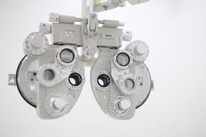 Phoropter for eye test, lenses glasses for eye check in optical store photo