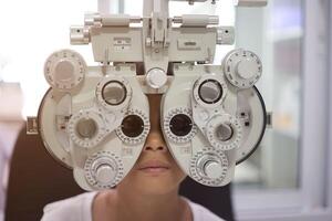 Child eye exam, kid eye test, Phoropter eye test photo