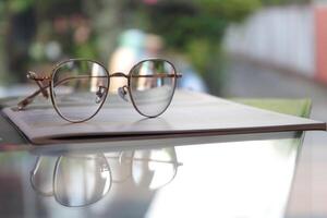 Eyeglasses on table, progressive lenses, eyeglasses for the elderly, glasses progressive lens, eyeglass progressive lens, close-up of glasses on lenses test, looking through glasses photo