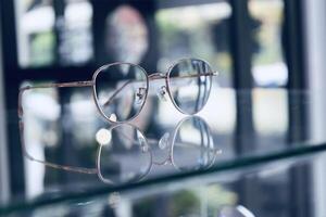 Eyeglasses on table, progressive lenses, eyeglasses for the elderly, glasses progressive lens, eyeglass progressive lens, close-up of glasses on lenses test, looking through glasses photo