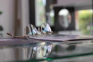 Eyeglasses on table, progressive lenses, eyeglasses for the elderly, glasses progressive lens, eyeglass progressive lens, close-up of glasses on lenses test, looking through glasses photo