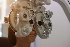 Child eye exam, kid eye test, Phoropter eye test photo