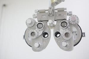 Phoropter for eye test, lenses glasses for eye check in optical store photo