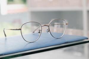 Eyeglasses on table, progressive lenses, eyeglasses for the elderly, glasses progressive lens, eyeglass progressive lens, close-up of glasses on lenses test, looking through glasses photo