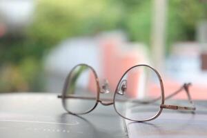 los anteojos en mesa, progresivo lentes, los anteojos para el anciano, lentes progresivo lente, lente progresivo lente, de cerca de lentes en lentes prueba, mirando mediante lentes foto