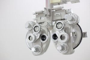 Phoropter for eye test, lenses glasses for eye check in optical store photo