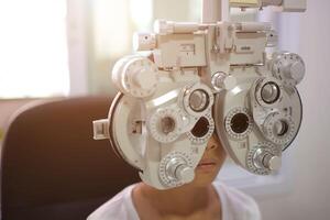 Child eye exam, kid eye test, Phoropter eye test photo