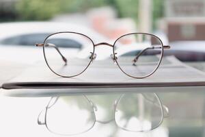 Eyeglasses on table, progressive lenses, eyeglasses for the elderly, glasses progressive lens, eyeglass progressive lens, close-up of glasses on lenses test, looking through glasses photo
