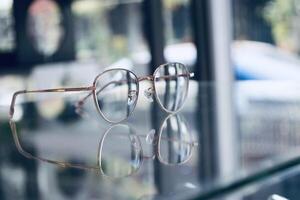 Eyeglasses on table, progressive lenses, eyeglasses for the elderly, glasses progressive lens, eyeglass progressive lens, close-up of glasses on lenses test, looking through glasses photo