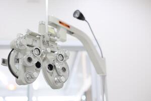 Phoropter for eye test, lenses glasses for eye check in optical store photo