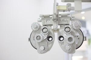 Phoropter for eye test, lenses glasses for eye check in optical store photo