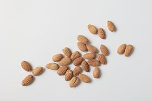 Almond on white background, brown almonds photo