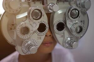 Child eye exam, kid eye test, Phoropter eye test photo