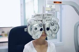 Child eye exam, kid eye test, Phoropter eye test photo