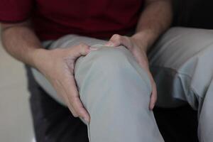 Knee massage to relieve pain, osteoarthritis, knee pain, knee inflammation photo