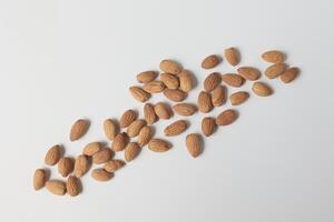 Almond on white background, brown almonds photo