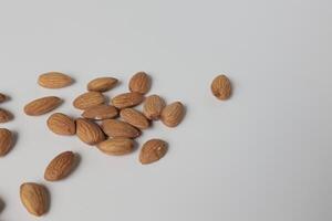 Almond on white background, brown almonds photo