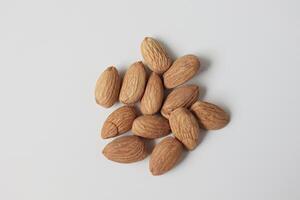 Almond on white background, brown almonds photo