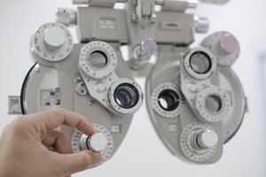 Phoropter for eye test, lenses glasses for eye check in optical store photo