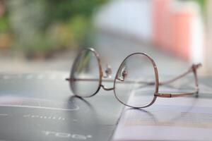 Eyeglasses on table, progressive lenses, eyeglasses for the elderly, glasses progressive lens, eyeglass progressive lens, close-up of glasses on lenses test, looking through glasses photo