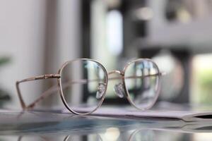 Eyeglasses on table, progressive lenses, eyeglasses for the elderly, glasses progressive lens, eyeglass progressive lens, close-up of glasses on lenses test, looking through glasses photo