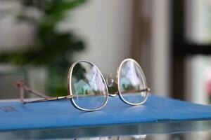 Eyeglasses on table, progressive lenses, eyeglasses for the elderly, glasses progressive lens, eyeglass progressive lens, close-up of glasses on lenses test, looking through glasses photo