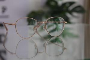Eyeglasses on table, progressive lenses, eyeglasses for the elderly, glasses progressive lens, eyeglass progressive lens, close-up of glasses on lenses test, looking through glasses photo