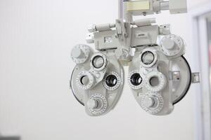 Phoropter for eye test, lenses glasses for eye check in optical store photo