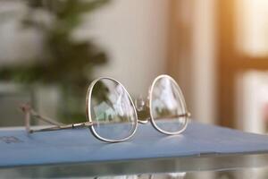 Eyeglasses on table, progressive lenses, eyeglasses for the elderly, glasses progressive lens, eyeglass progressive lens, close-up of glasses on lenses test, looking through glasses photo