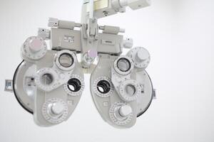 Phoropter for eye test, lenses glasses for eye check in optical store photo