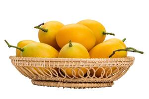 Closeup of ripe Marian Plum in bamboo basket on white background with clipping path. Delicious sweet yellow marian plum in Thailand. photo