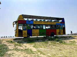 Double-decker tourist bus at cox bazar sea beach photo