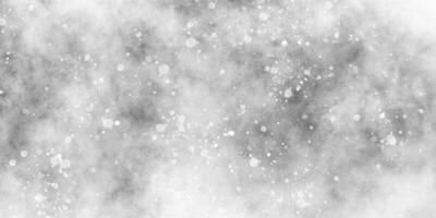 resumen invierno Mañana brillante blanco nieve es que cae al azar con varios bokeh partículas, hermosa gris acuarela antecedentes con Brillantina partículas para fondo de pantalla y diseño y presentación. foto