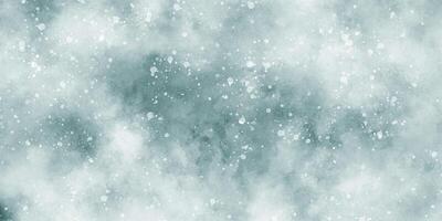 Beautiful winter background of snow floating into air randomly, light blue bokeh background for wallpaper, abstract sky blue cloudy watercolor background with bubbles and watercolor stains. photo