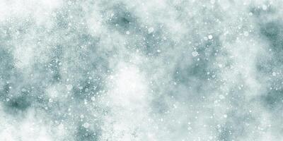 Beautiful winter background of snow floating into air randomly, light blue bokeh background for wallpaper, abstract sky blue cloudy watercolor background with bubbles and watercolor stains. photo