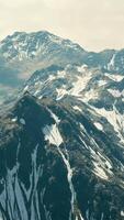 Aerial Over Valley With Snow Capped Mountains In Distance video