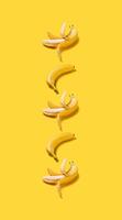 Banner vertical bananas with hard shadows pattern on yellow background photo