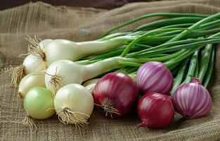 AI generated Onions and spring onions on sack on wooden background photo