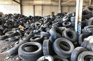 AI generated Old used tires piled up in junkyard photo