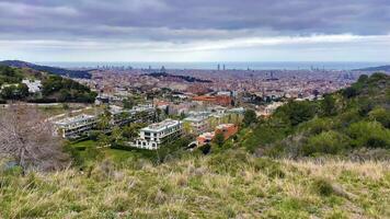 Panoramic view of Barcelona city from the hill, rainy weather landscape photo