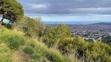 Panoramic view of Barcelona city from the hill, rainy spring weather landscape photo