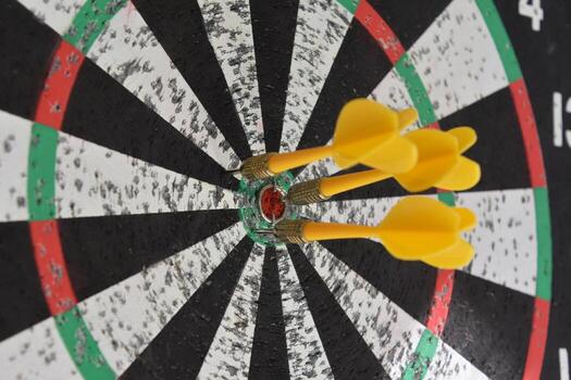 Yellow Darts Around the Bullseye of a Dartboard photo