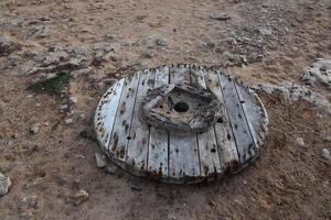 Round Wooden Spool on the Ground photo