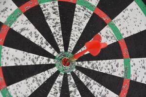 Dart in the Bullseye of a Dartboard photo