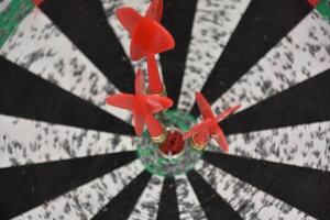 Close up of Darts in the Center of a Dartboard photo