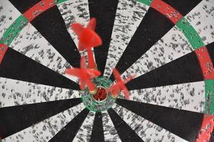 Bullseye with Darts in the Center of the Board photo