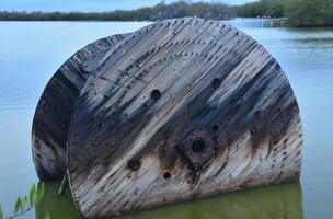 Wooden Spool in Shallow Ocean Waters photo