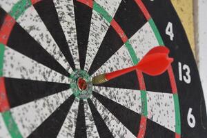 Red Dart in the Center of a Dart Board photo