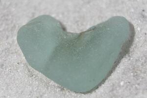 Heart Shaped Sea Glass on a White Sand Beach photo